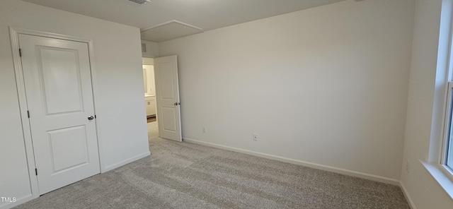 unfurnished bedroom featuring light carpet