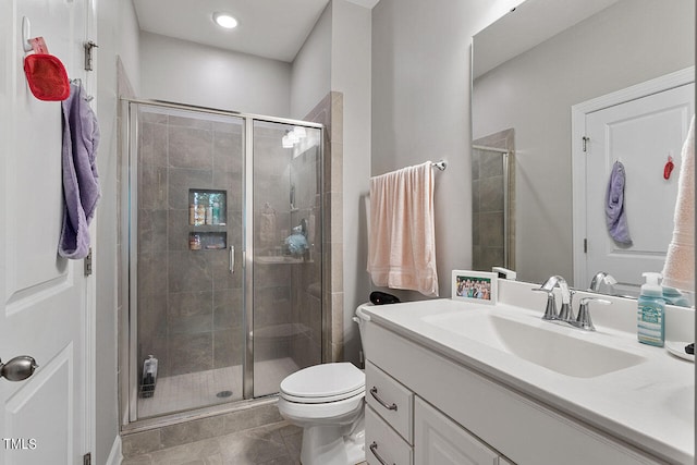 bathroom featuring tile patterned floors, walk in shower, vanity, and toilet