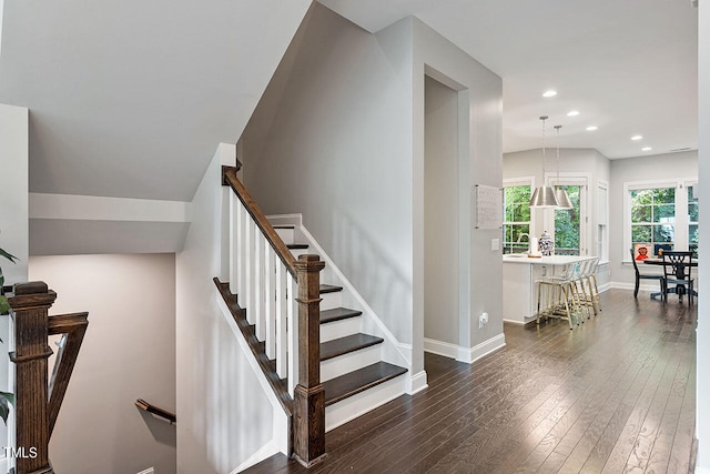 stairs featuring hardwood / wood-style floors