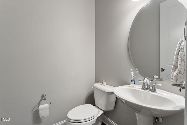 bathroom featuring toilet and sink