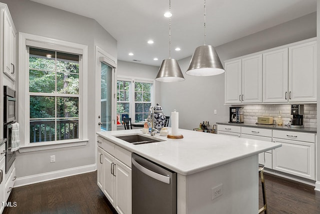 kitchen with an island with sink, white cabinetry, dark hardwood / wood-style flooring, and stainless steel dishwasher