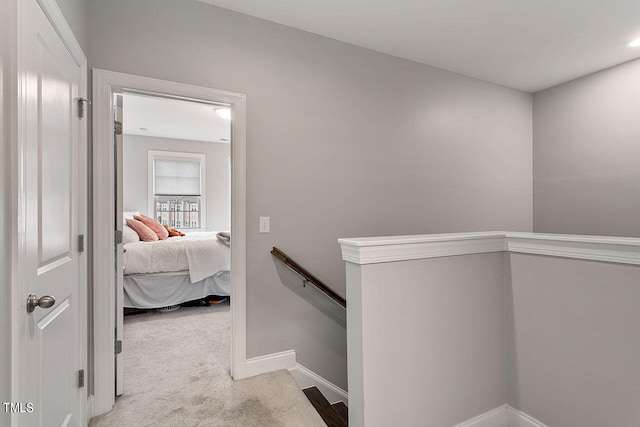 corridor featuring light colored carpet