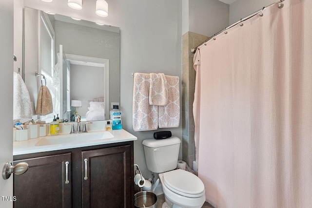 bathroom with vanity, toilet, and a shower with shower curtain