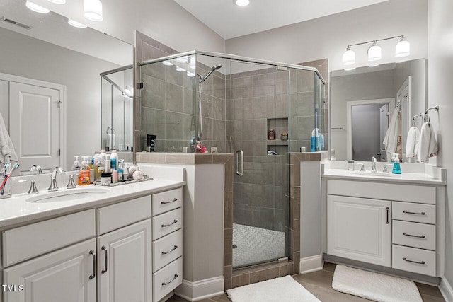 bathroom featuring walk in shower and vanity