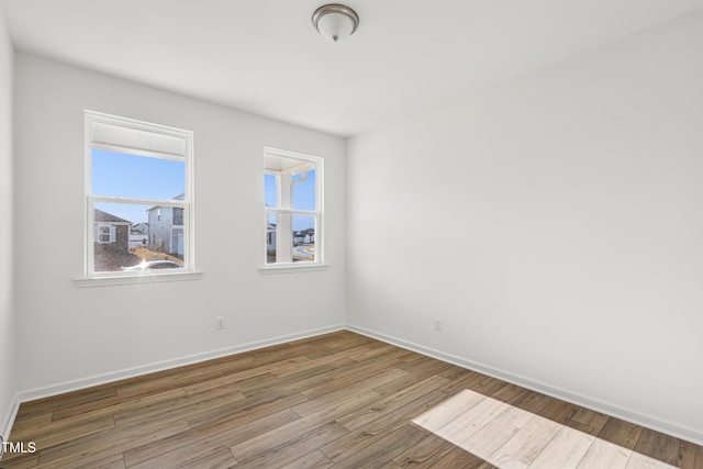 spare room featuring hardwood / wood-style flooring