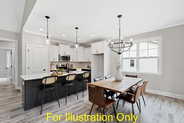 dining room featuring an inviting chandelier, sink, crown molding, and light hardwood / wood-style floors