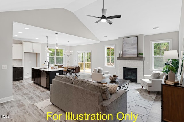 living room featuring vaulted ceiling, ceiling fan with notable chandelier, a fireplace, sink, and light hardwood / wood-style flooring