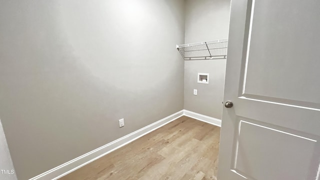 washroom with hookup for a washing machine and light hardwood / wood-style flooring