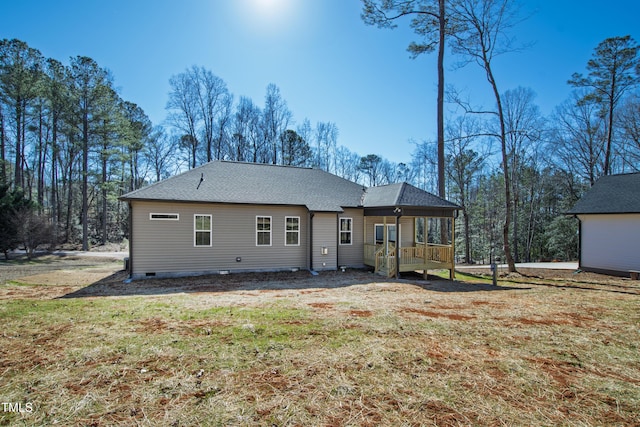 back of house featuring covered porch and a lawn