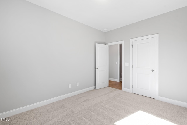 unfurnished bedroom featuring light colored carpet