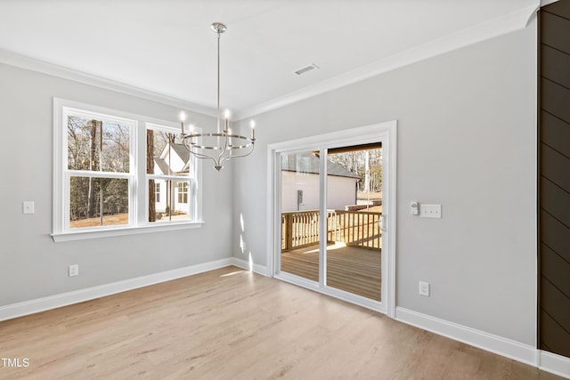 unfurnished dining area featuring hardwood / wood-style floors, a notable chandelier, and ornamental molding