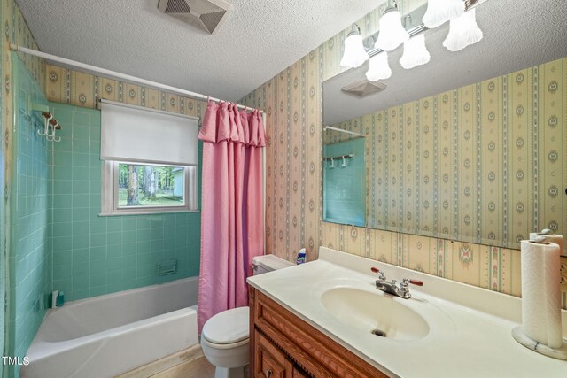 full bathroom featuring toilet, a textured ceiling, shower / bath combo, and vanity