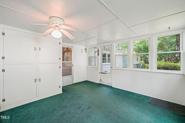 unfurnished sunroom with ceiling fan