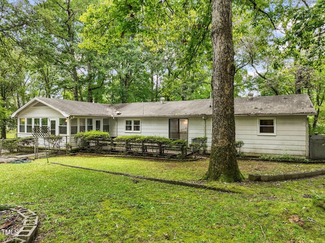 rear view of property with a yard