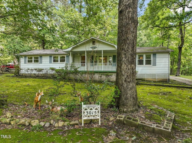 ranch-style house with a front yard and a porch