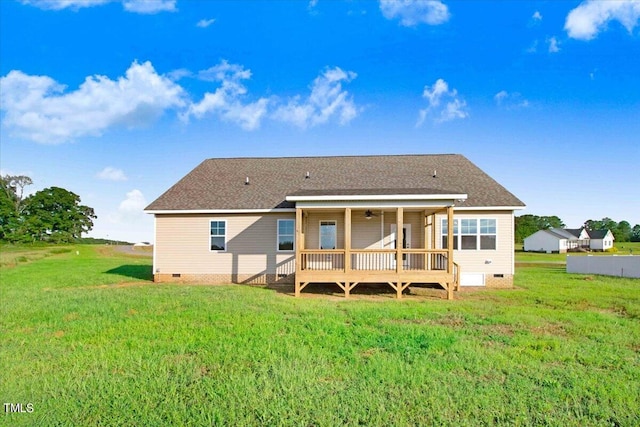 back of property featuring a lawn and a deck