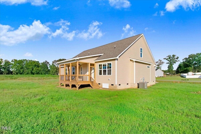 back of house with a lawn and central air condition unit