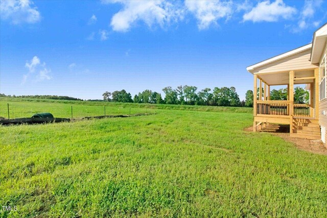 view of yard with a rural view