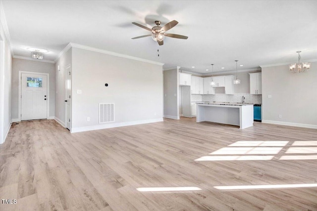 unfurnished living room featuring light wood-type flooring, ceiling fan with notable chandelier, and ornamental molding