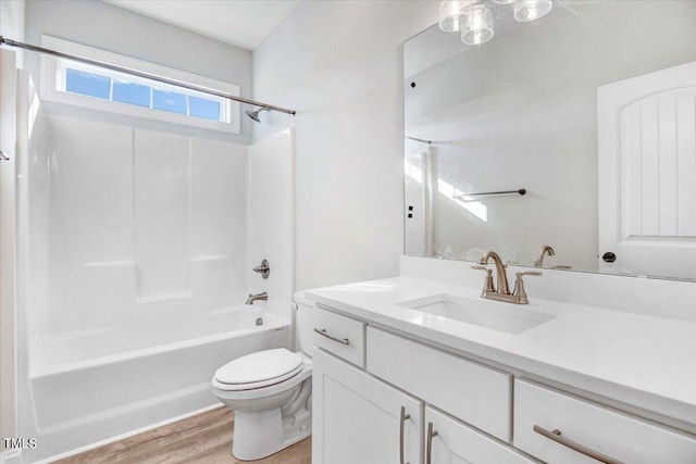 full bathroom with bathtub / shower combination, hardwood / wood-style flooring, vanity, and toilet