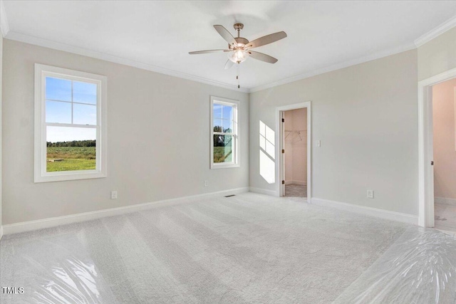 carpeted empty room featuring ceiling fan and ornamental molding