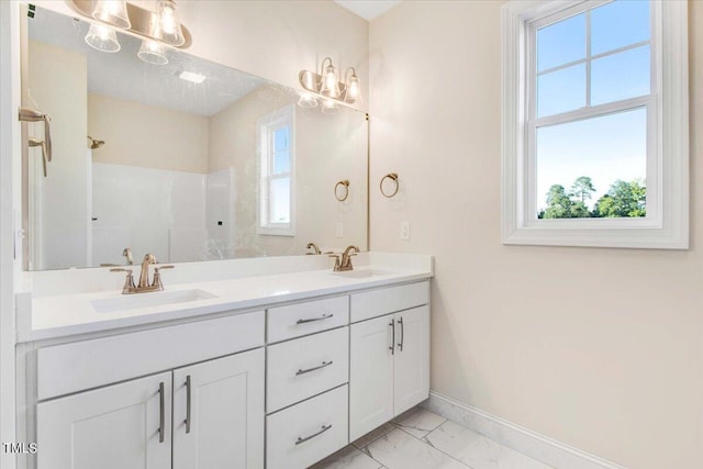 bathroom with walk in shower and vanity