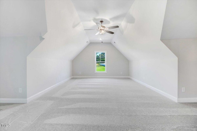 additional living space with ceiling fan, light colored carpet, and lofted ceiling