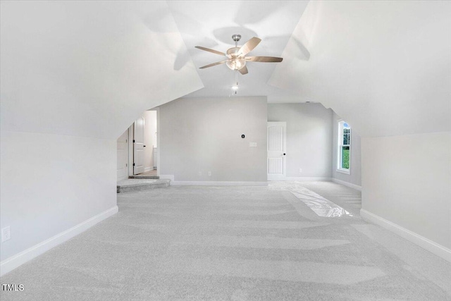 additional living space featuring lofted ceiling, ceiling fan, and light colored carpet