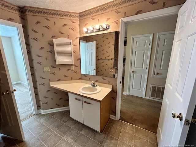 bathroom with vanity and a textured ceiling