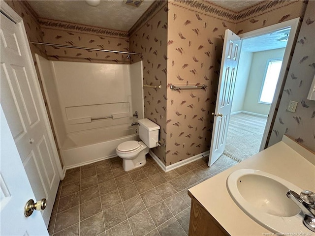 full bathroom with tub / shower combination, vanity, a textured ceiling, tile patterned flooring, and toilet