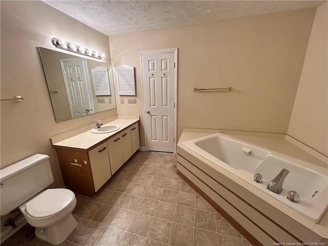 bathroom with vanity, a textured ceiling, a tub to relax in, tile patterned floors, and toilet