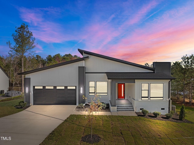 contemporary house with a yard and a garage