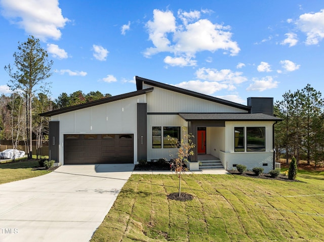 view of front of property featuring a garage and a front lawn