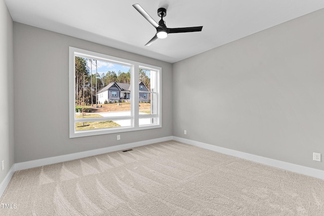 empty room with ceiling fan and carpet floors