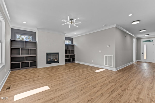 unfurnished living room featuring a fireplace, light hardwood / wood-style floors, and plenty of natural light