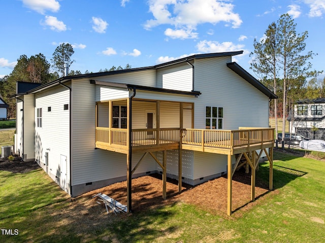 rear view of house with central air condition unit, a lawn, and a wooden deck