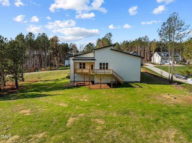 rear view of property featuring a wooden deck and a yard