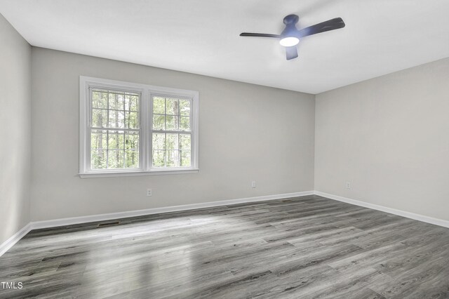 unfurnished room with ceiling fan and wood-type flooring