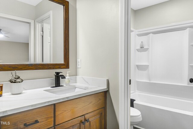 full bathroom with shower / tub combination, ceiling fan, vanity, and toilet