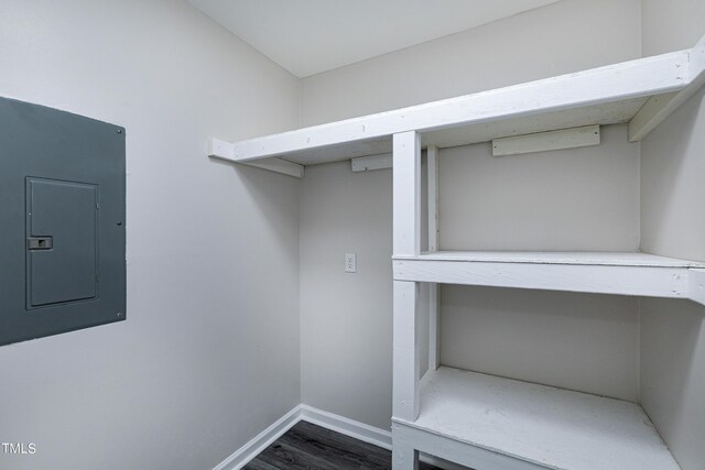 interior space with dark hardwood / wood-style flooring and electric panel