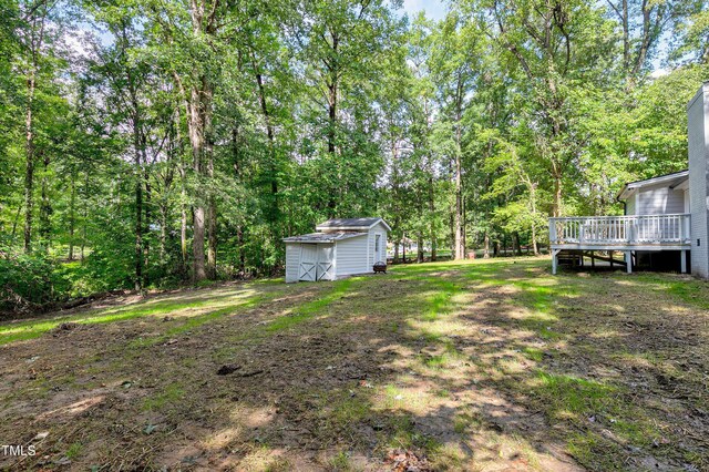 view of yard with a storage shed and a deck