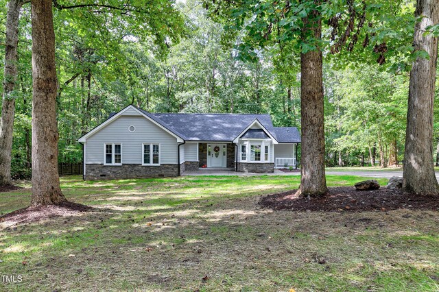 single story home with a porch and a front yard