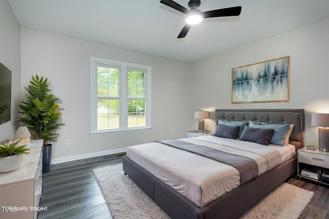 bedroom with ceiling fan and dark hardwood / wood-style floors