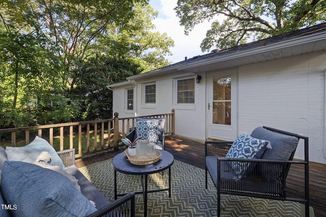 wooden terrace with an outdoor hangout area