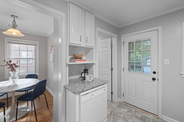 kitchen with white cabinets, white dishwasher, a wealth of natural light, and decorative light fixtures