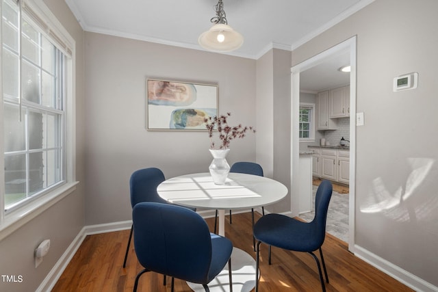 dining area featuring crown molding and hardwood / wood-style floors