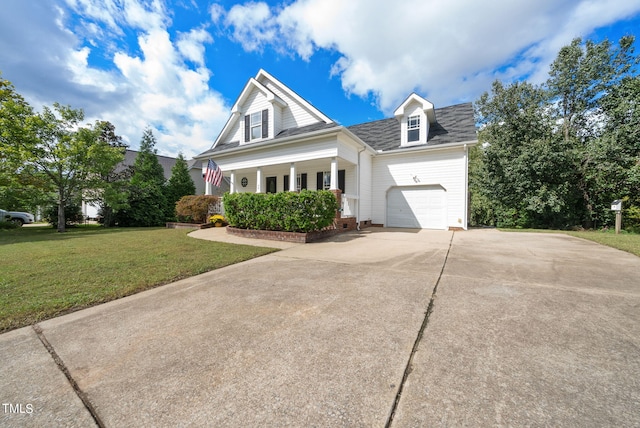 view of front of home with a front lawn, covered porch, and a garage