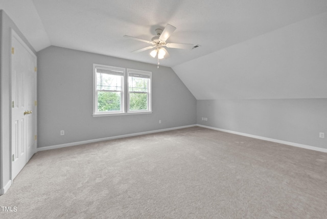 bonus room featuring vaulted ceiling, ceiling fan, and light colored carpet