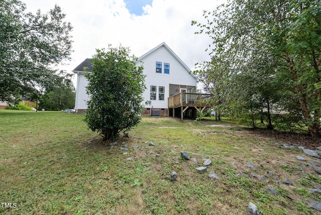 view of yard with central AC and a deck