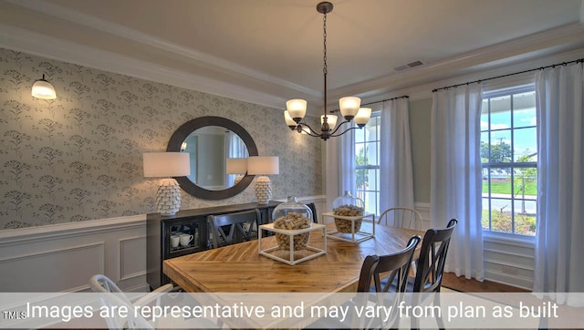 dining space with hardwood / wood-style flooring, a chandelier, and ornamental molding